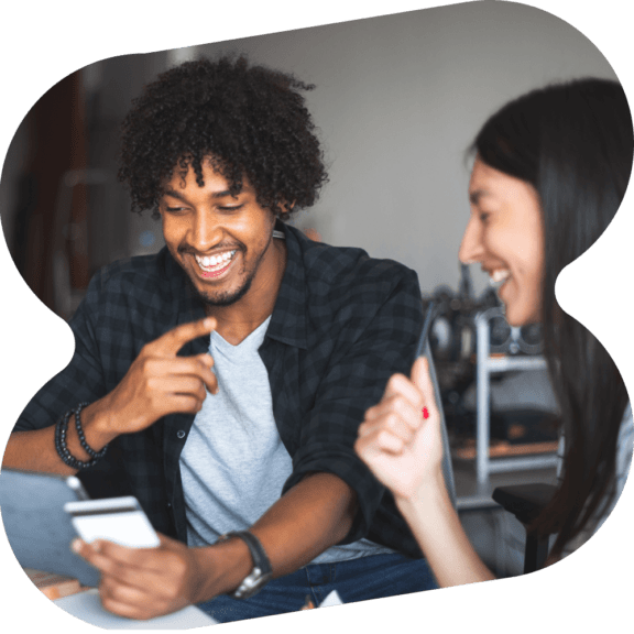 Man and woman holding a credit card, online shopping