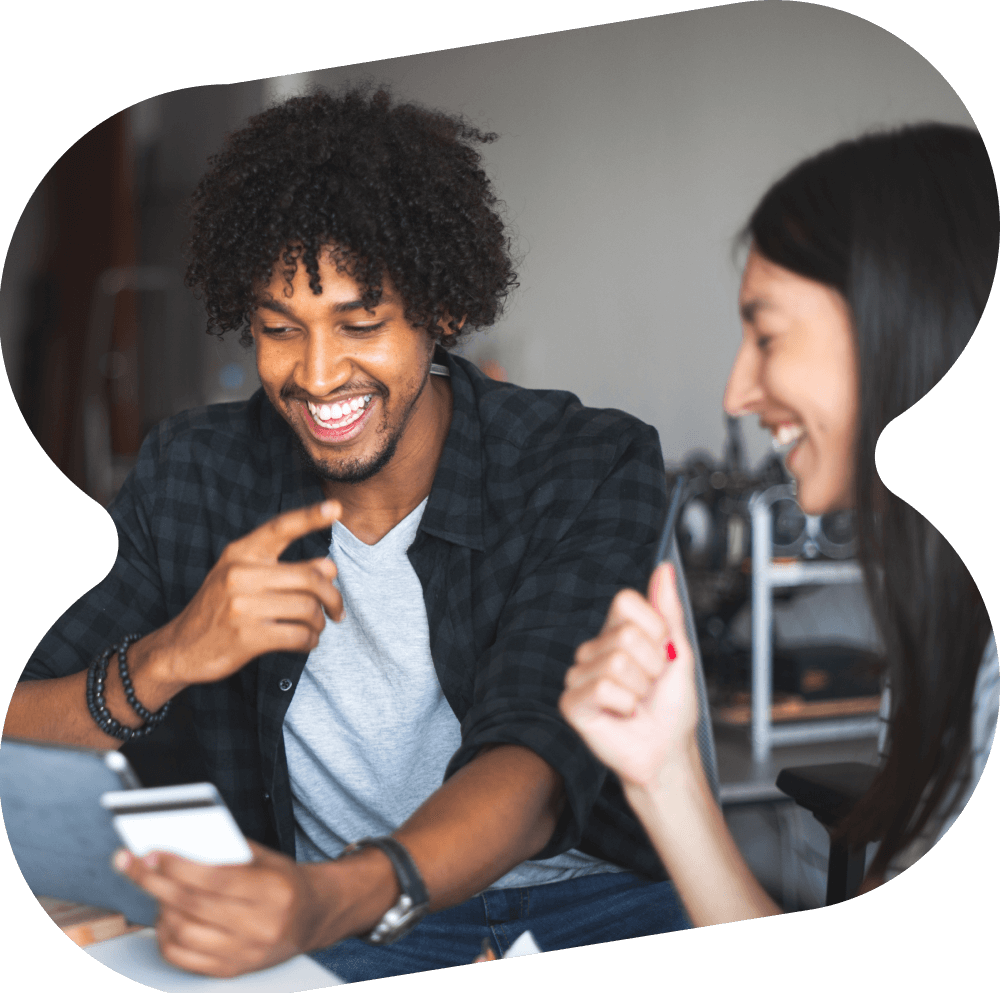 Man and woman holding a credit card, online shopping