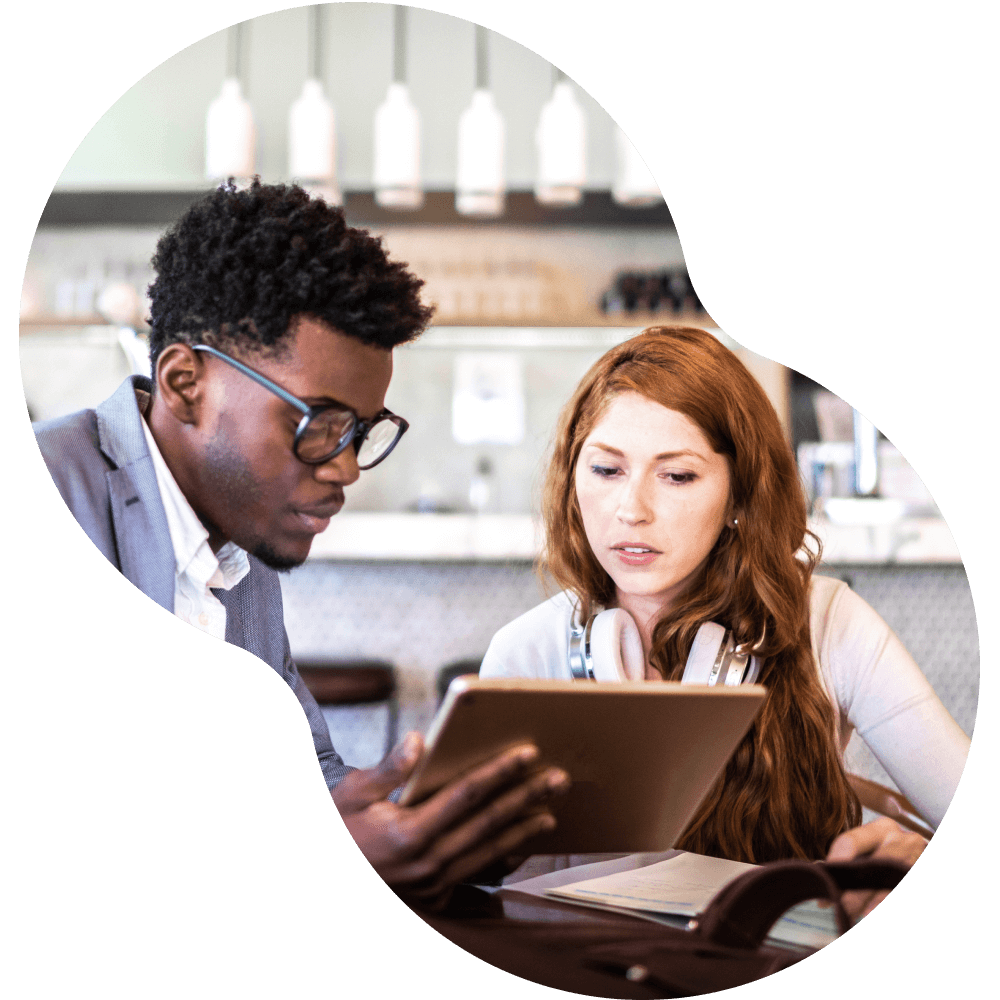 Man and woman reviewing a tablet together