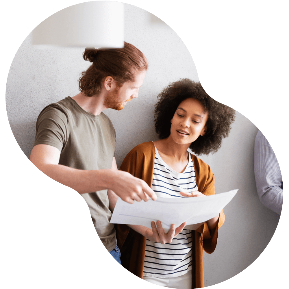 Man and woman holding large paper and viewing it