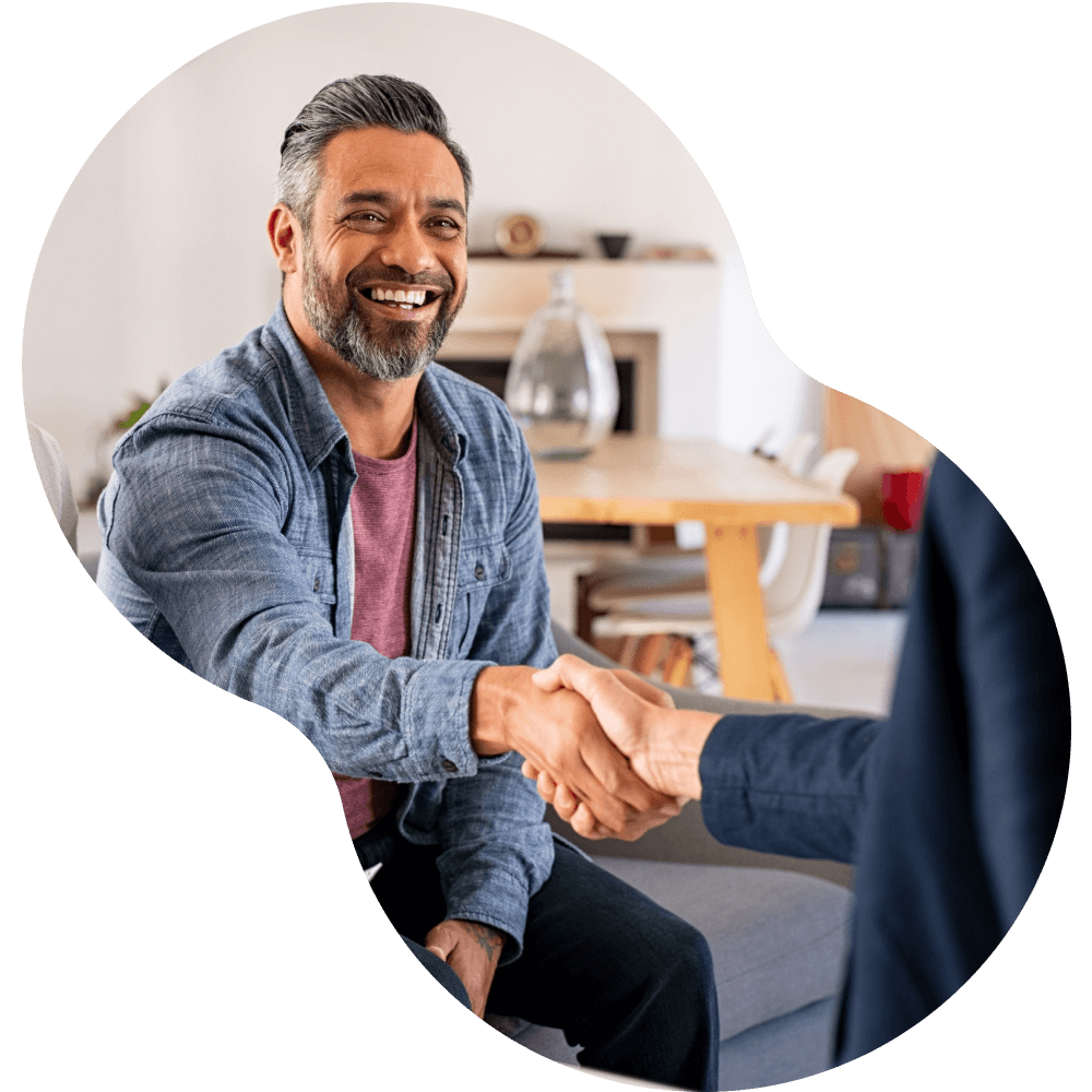 Older man shaking hands with another person