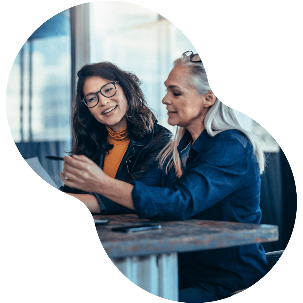 Two women reviewing paperwork together