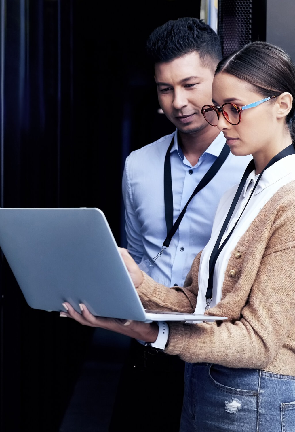 Young man and woman viewing a laptop at work.