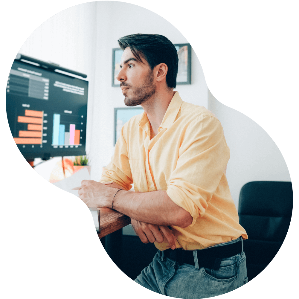 Young man looking at computer screen in office