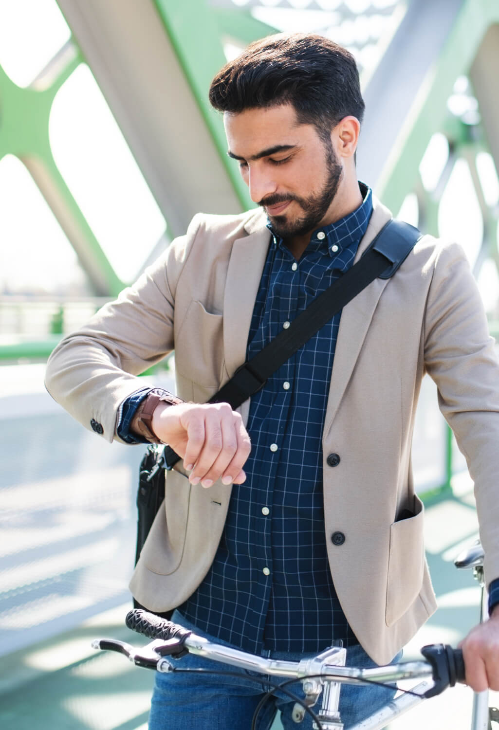 Man looking down at his watch while outdoors