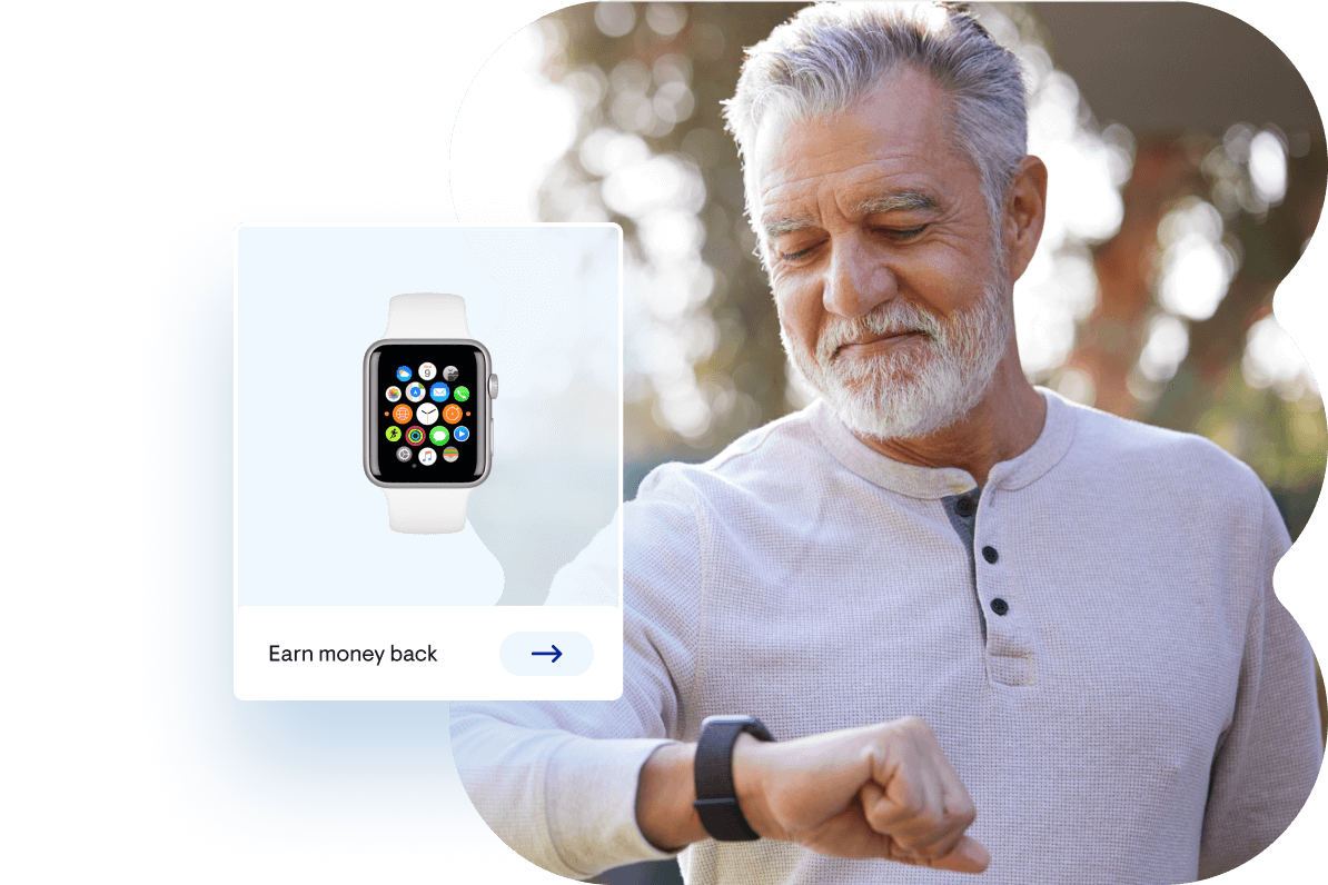 Man walking outdoors while looking down at his watch