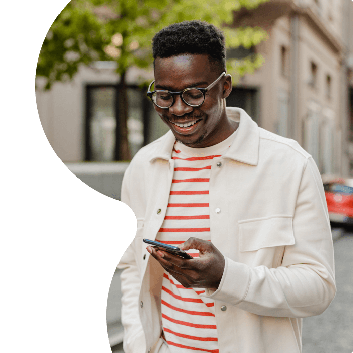 Man walking outside looking at phone