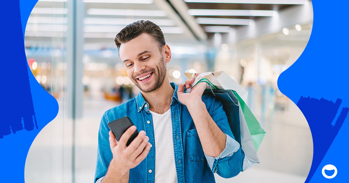 Smiling man interacting with a punch card rewards program on his mobile phone